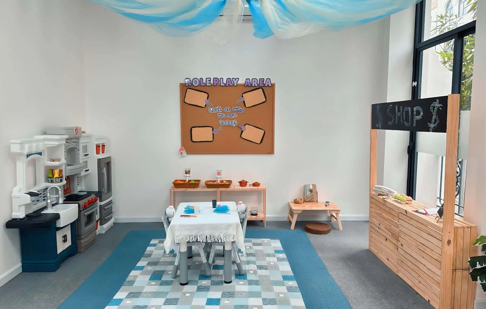 Role play area with play kitchen and shop counter